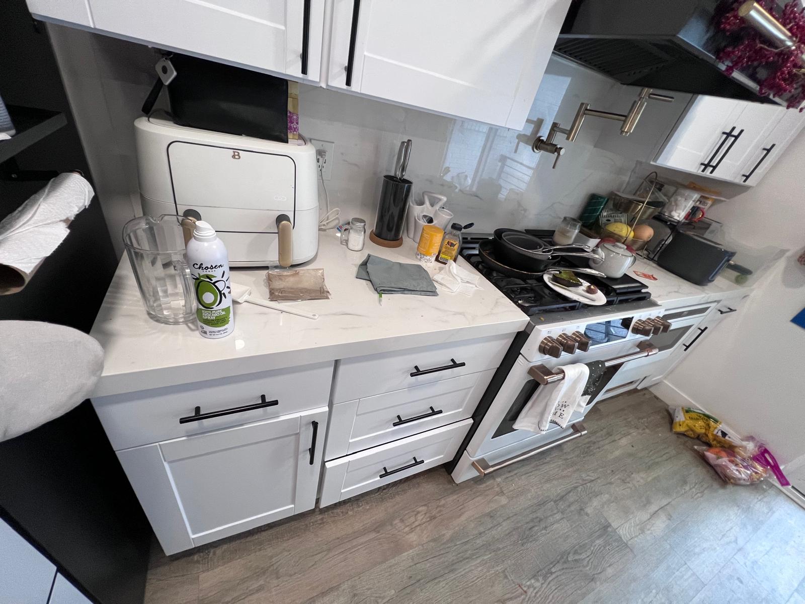 Residential kitchen after cleaning with clearer counters and cooking area.
